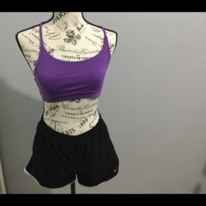Purple sports bra and Nike shorts